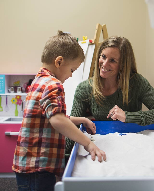 Therapist Sara Ranssi does play therapy with a young child
